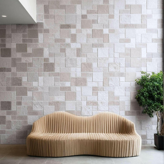Stylish interior featuring a travertine patterned wall and a modern, minimalist beige sofa.