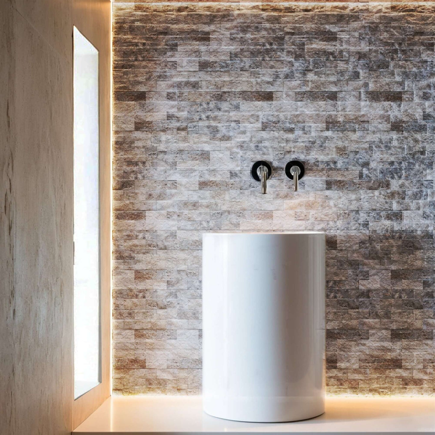 Blasted travertine wall with polished white vessel sink, highlighting minimalist design and premium natural stone craftsmanship.
