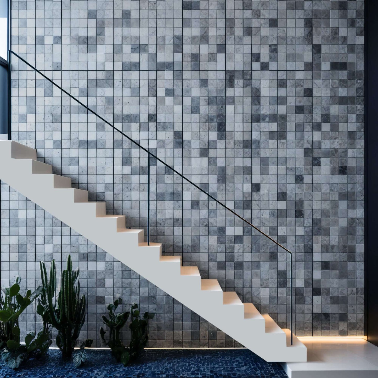 Elegant marble mosaic wall design paired with a minimalist staircase and indoor plants.