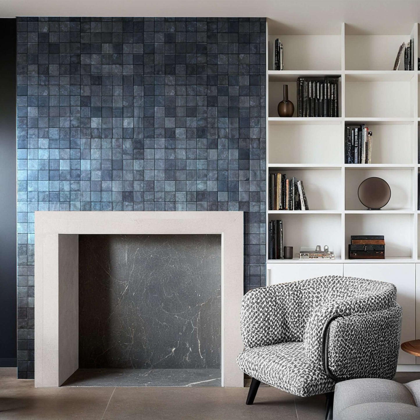 Elegant distressed marble mosaic fireplace feature with minimalist design and natural stone craftsmanship.