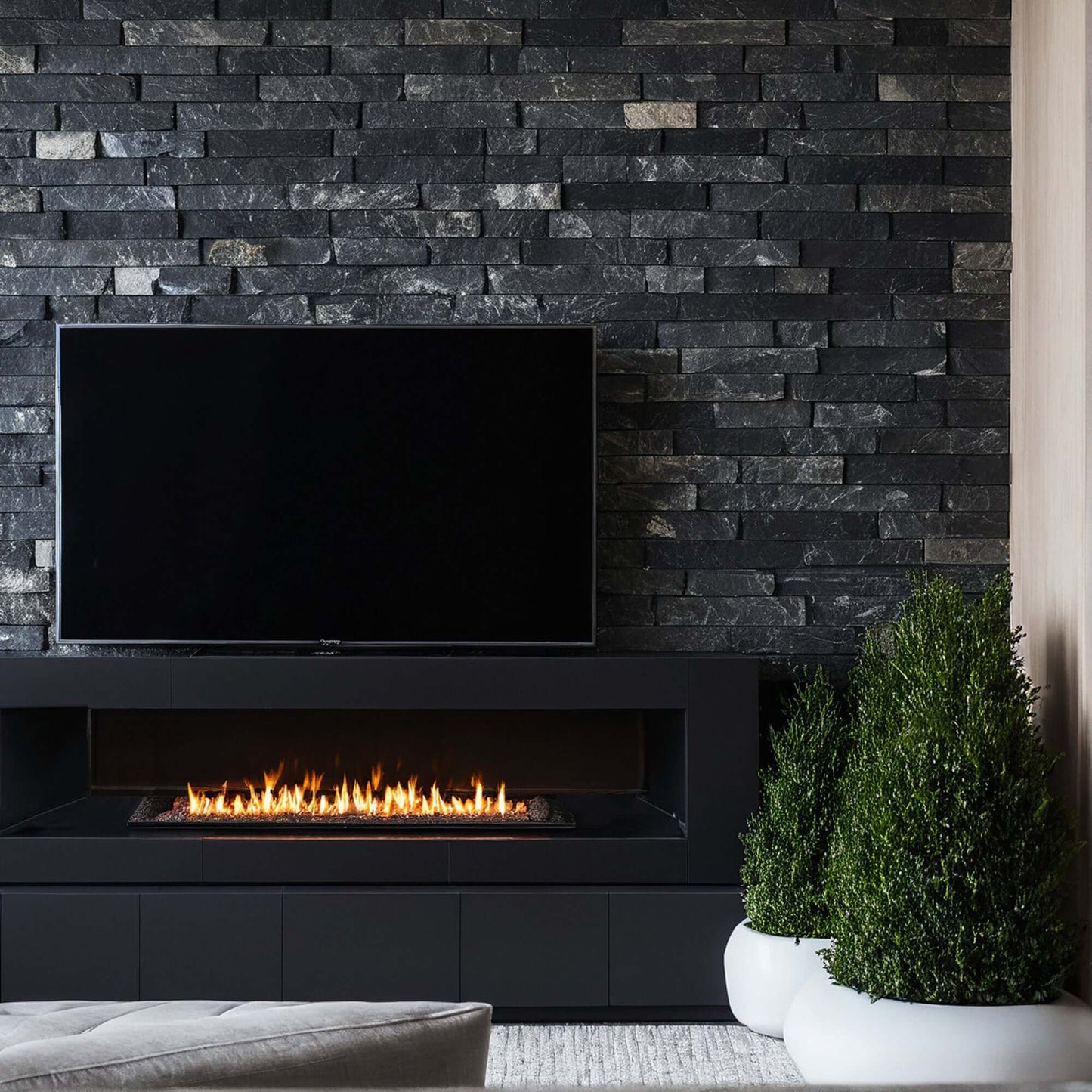 Stylish living room featuring a black stone wall, modern fireplace, and minimalist decor for elegant spaces.