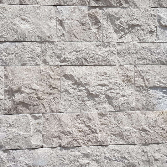 Textured travertine mosaic wall featuring premium stones with a natural finish, ideal for minimalist designs.