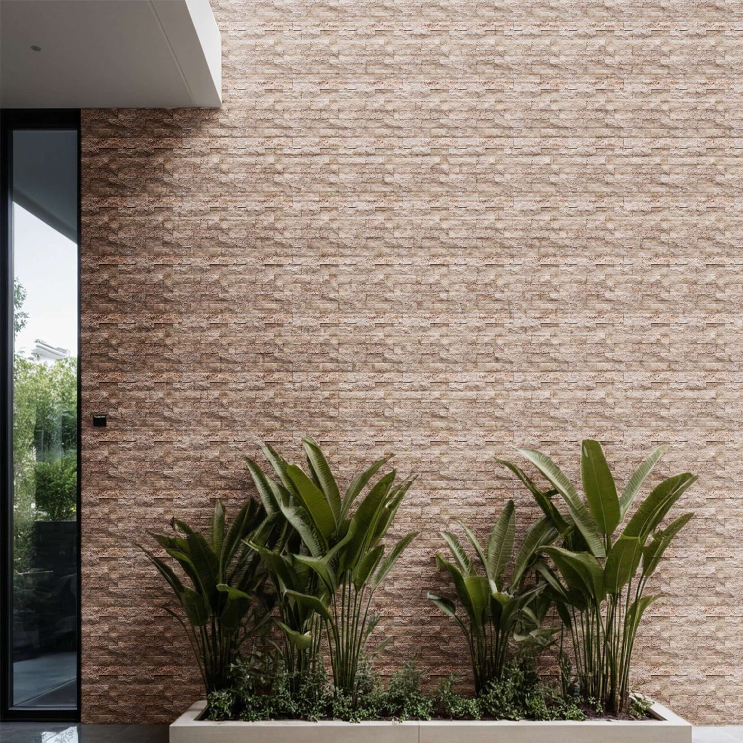 Travertine blasted brick mosaic wall with lush green plants, showcasing premium natural stone's elegance.