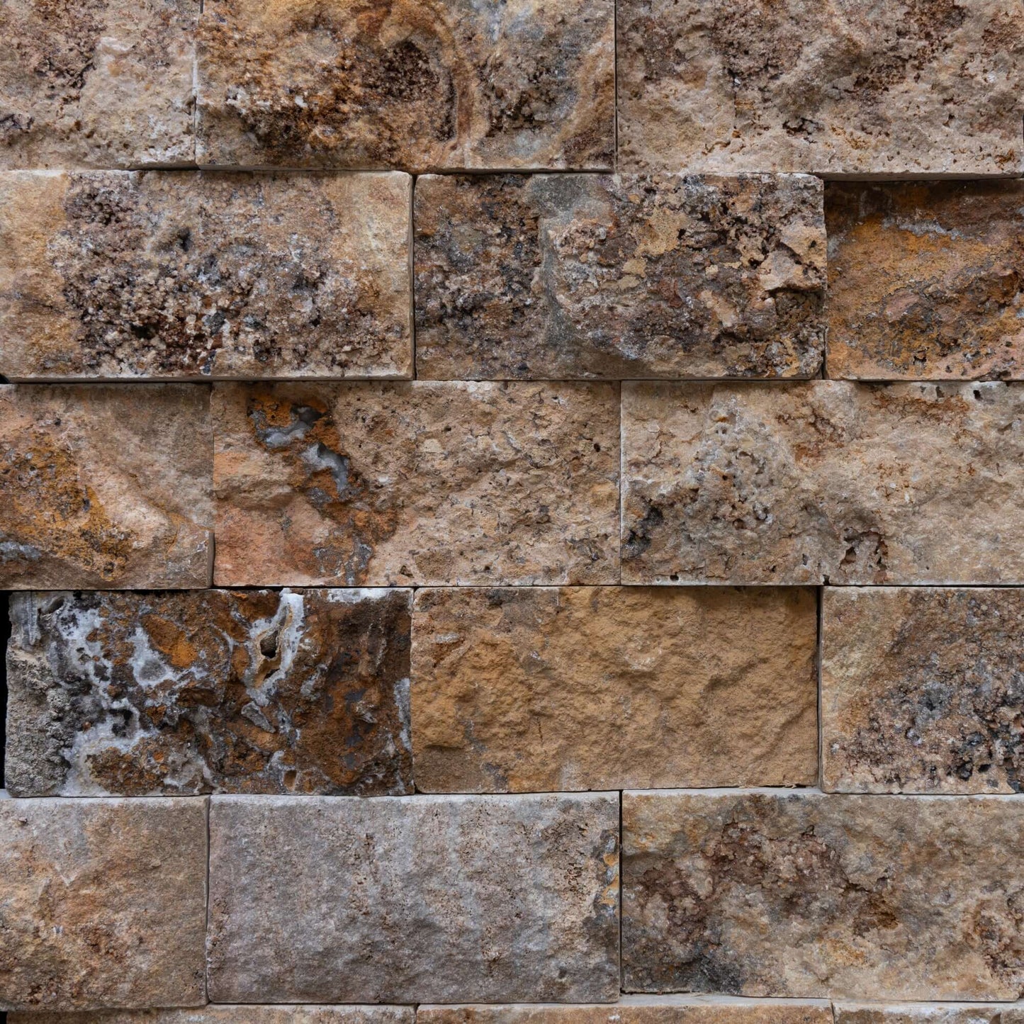 Blasted travertine stone wall tiles showcasing natural textures, perfect for elegant minimalist designs.