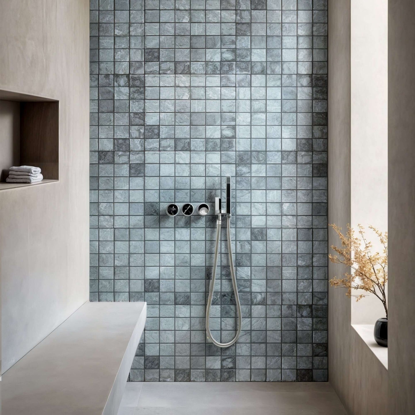 Elegant green marble mosaic wall tiles in a minimalist shower space with premium finishes.