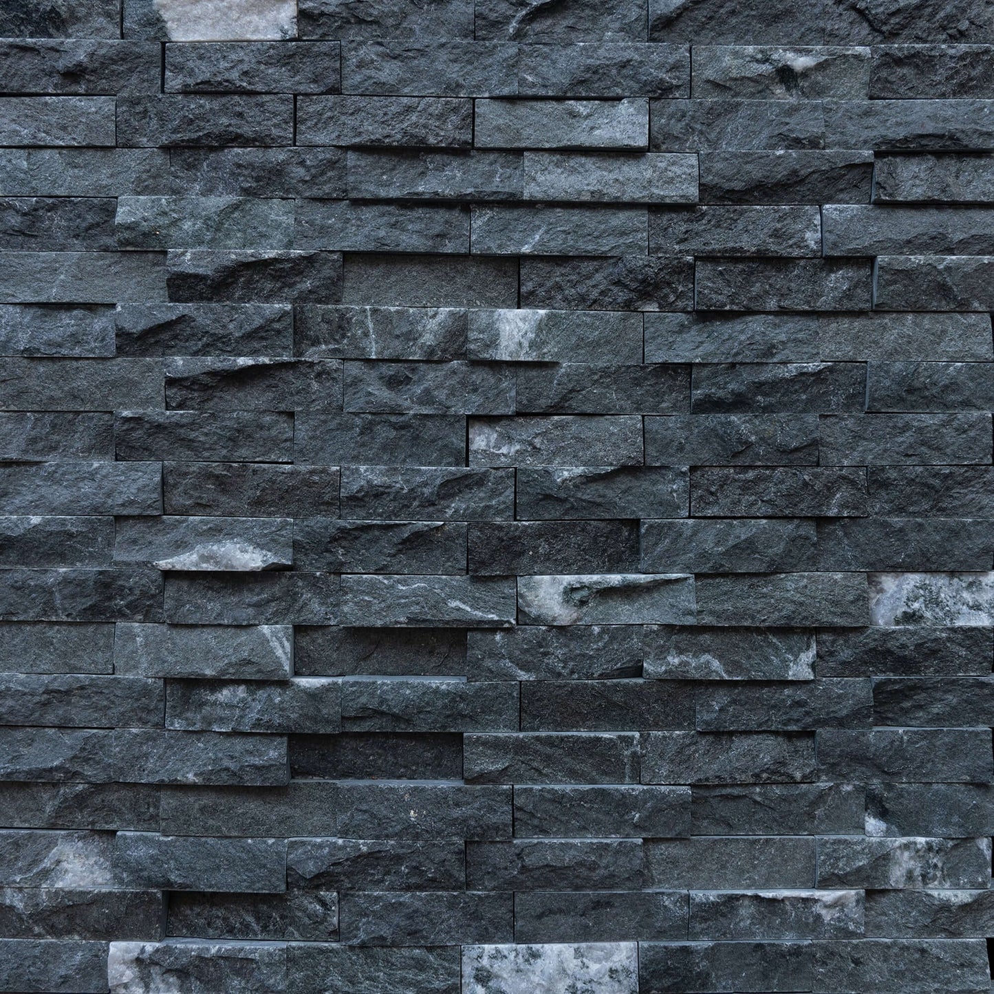 Black marble blasted mosaic wall, showcasing premium stone craftsmanship and minimalist design, ideal for elegant interiors.