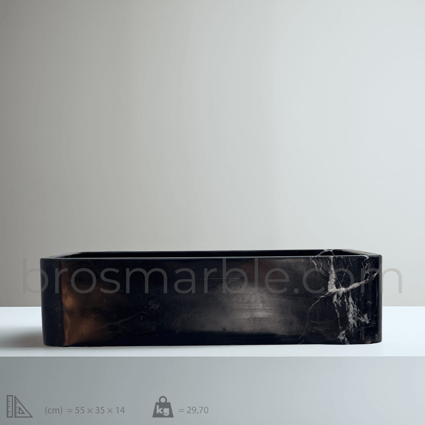 Black marble vessel sink with polished finish, showcasing minimalist design and luxury craftsmanship.