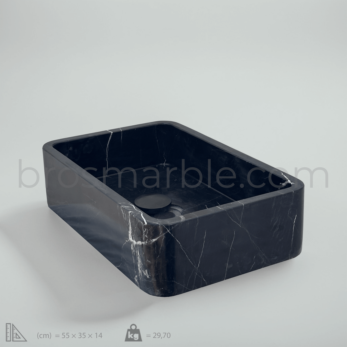 Black marble vessel sink featuring polished finish and minimalist design, ideal for luxury bathroom decor.