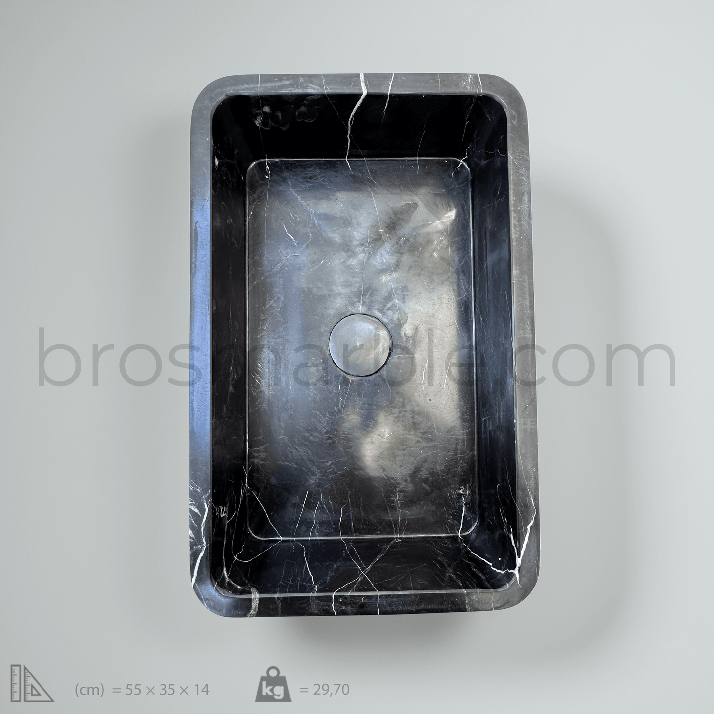 Black marble vessel sink with polished finish, showcasing minimalist design and luxurious craftsmanship.