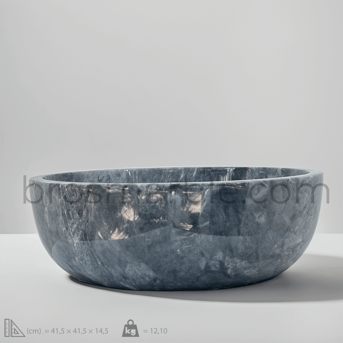 Handcrafted dark grey marble vessel sink with polished finish, showcasing minimalist design and natural stone elegance.