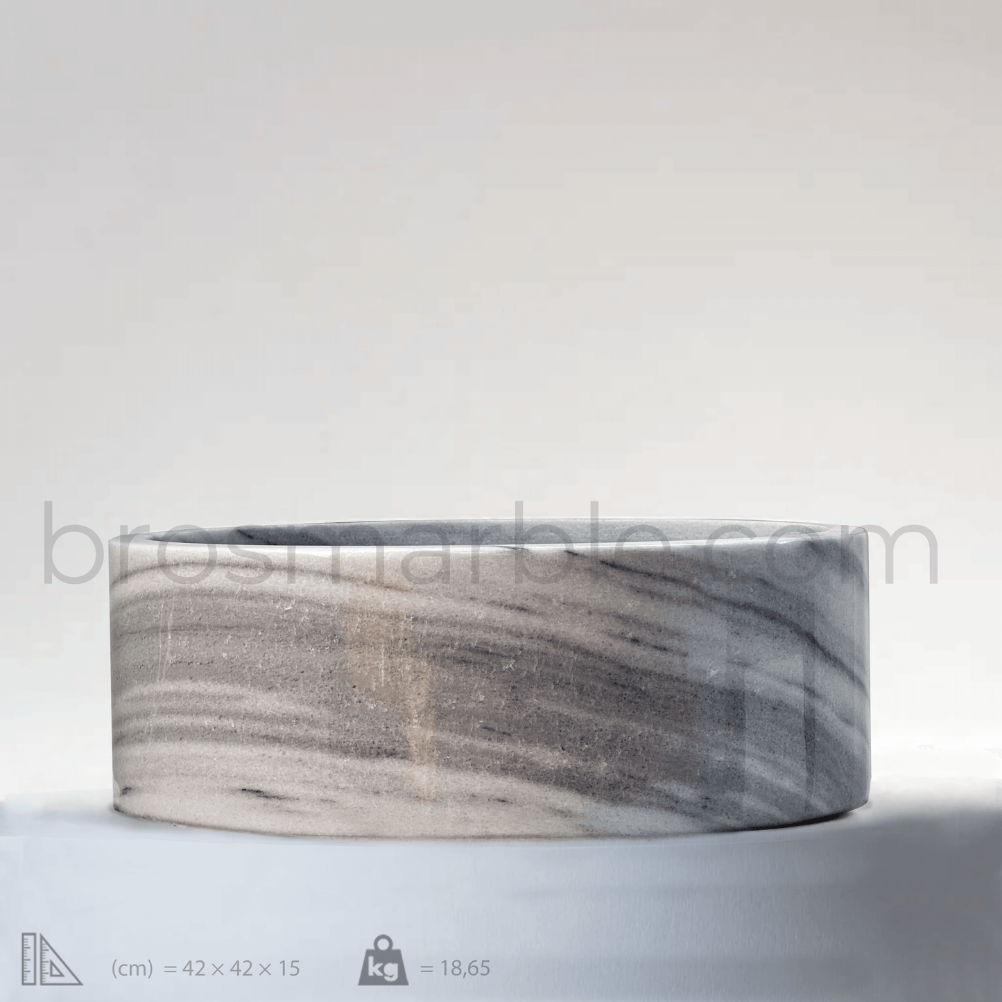 Gray marble cylindrical vessel sink featuring a polished finish and minimalist design, ideal for luxury bathrooms.
