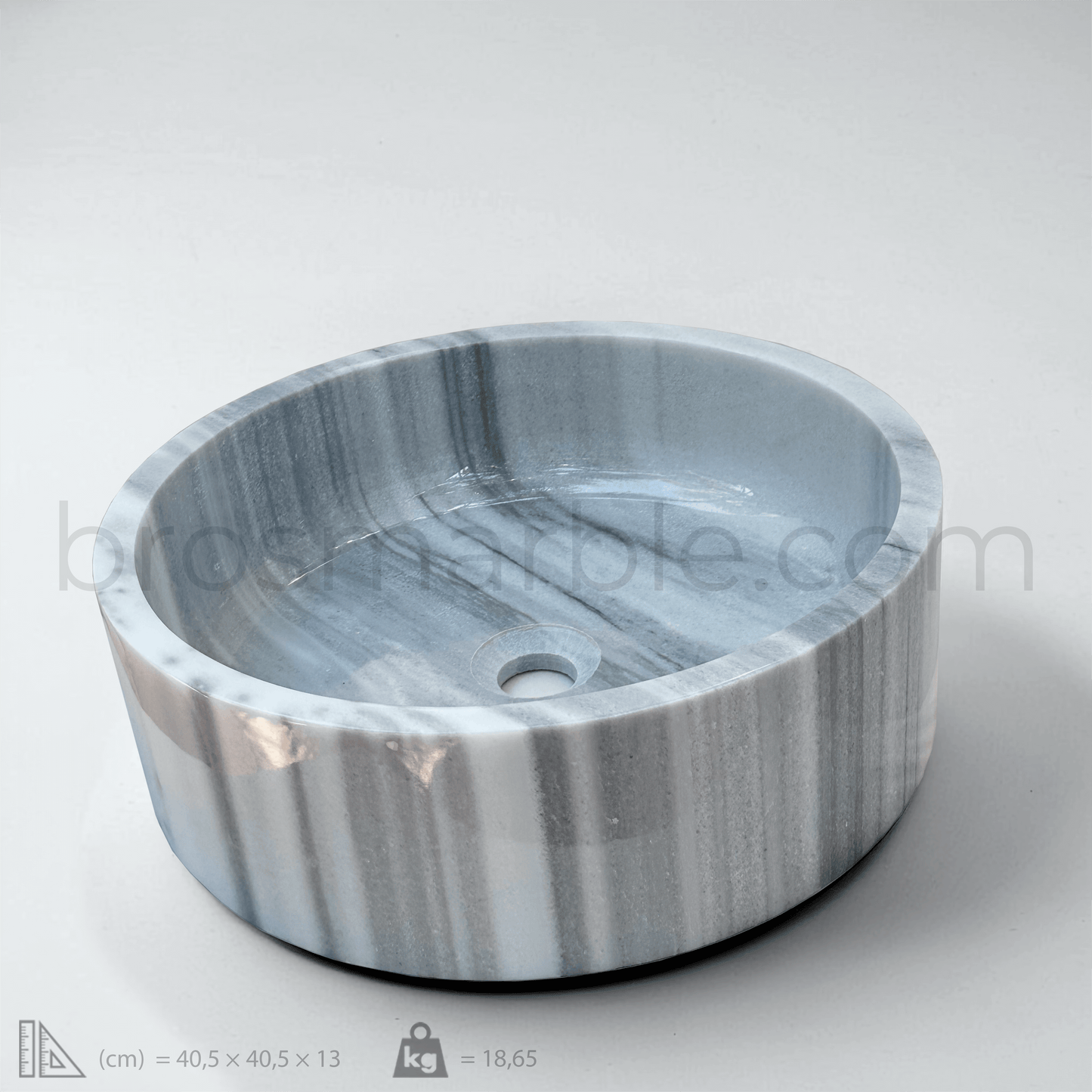 Gray marble vessel sink featuring a polished finish and minimalist design, showcasing unique veining patterns.