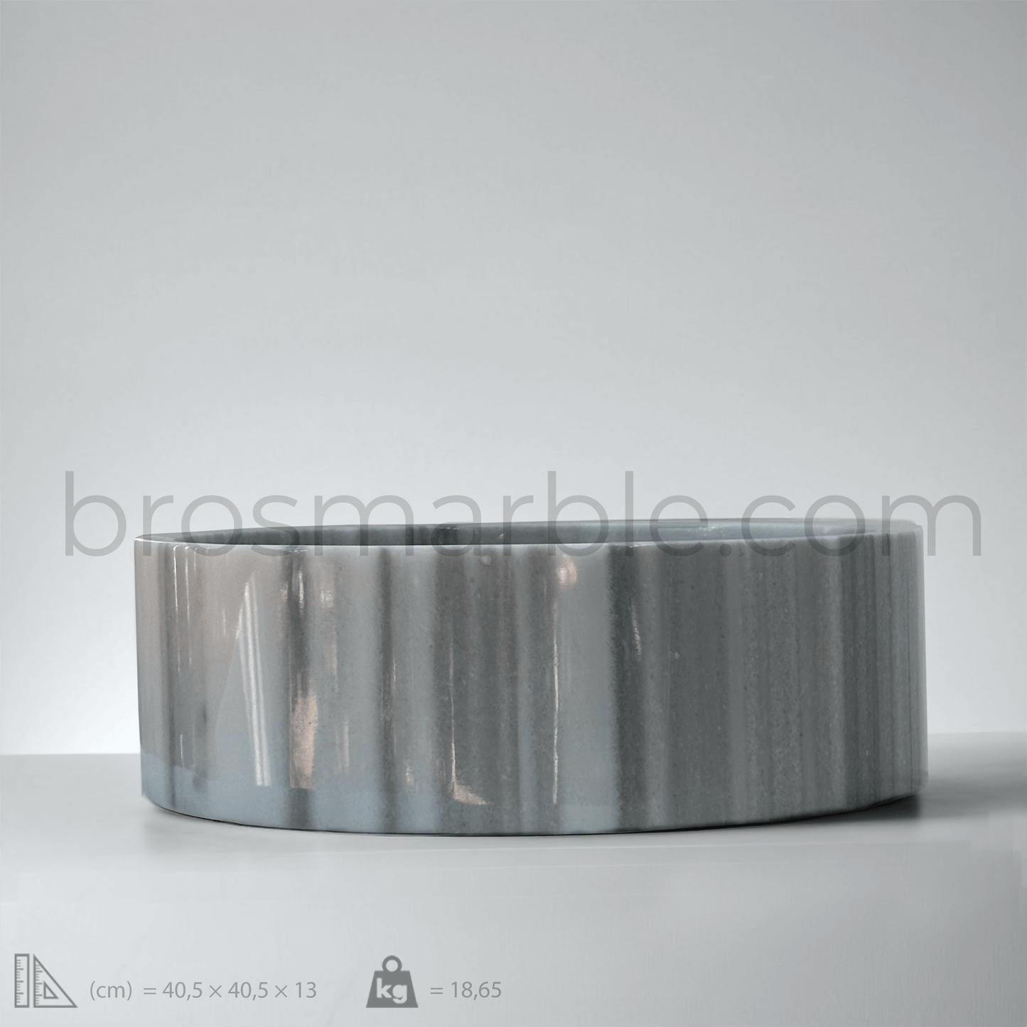Gray Marmara marble cylindrical vessel sink with polished finish, showcasing minimalist design and unique veining patterns.