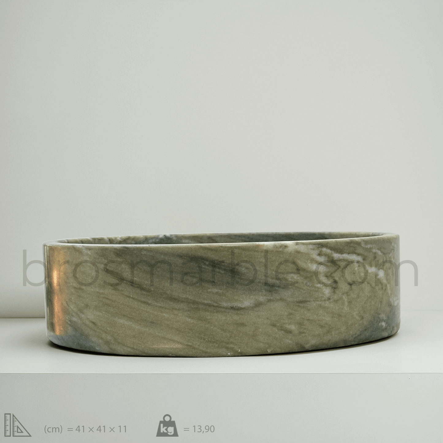 Handcrafted green marble vessel sink showcasing polished finish and minimalist design, perfect for luxury bathrooms.