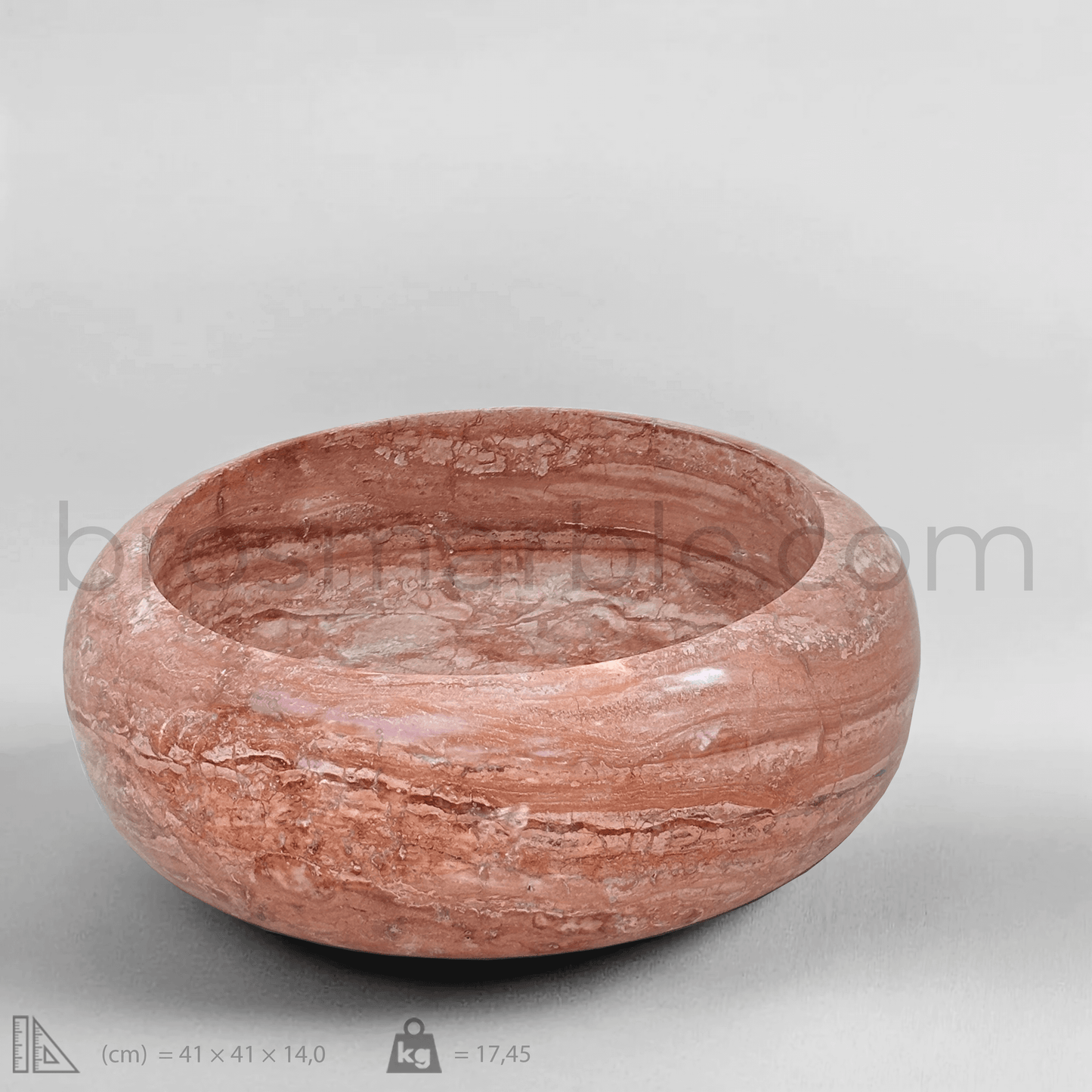 Handcrafted red travertine vessel sink with polished finish, showcasing minimalist design and unique natural stone veining.