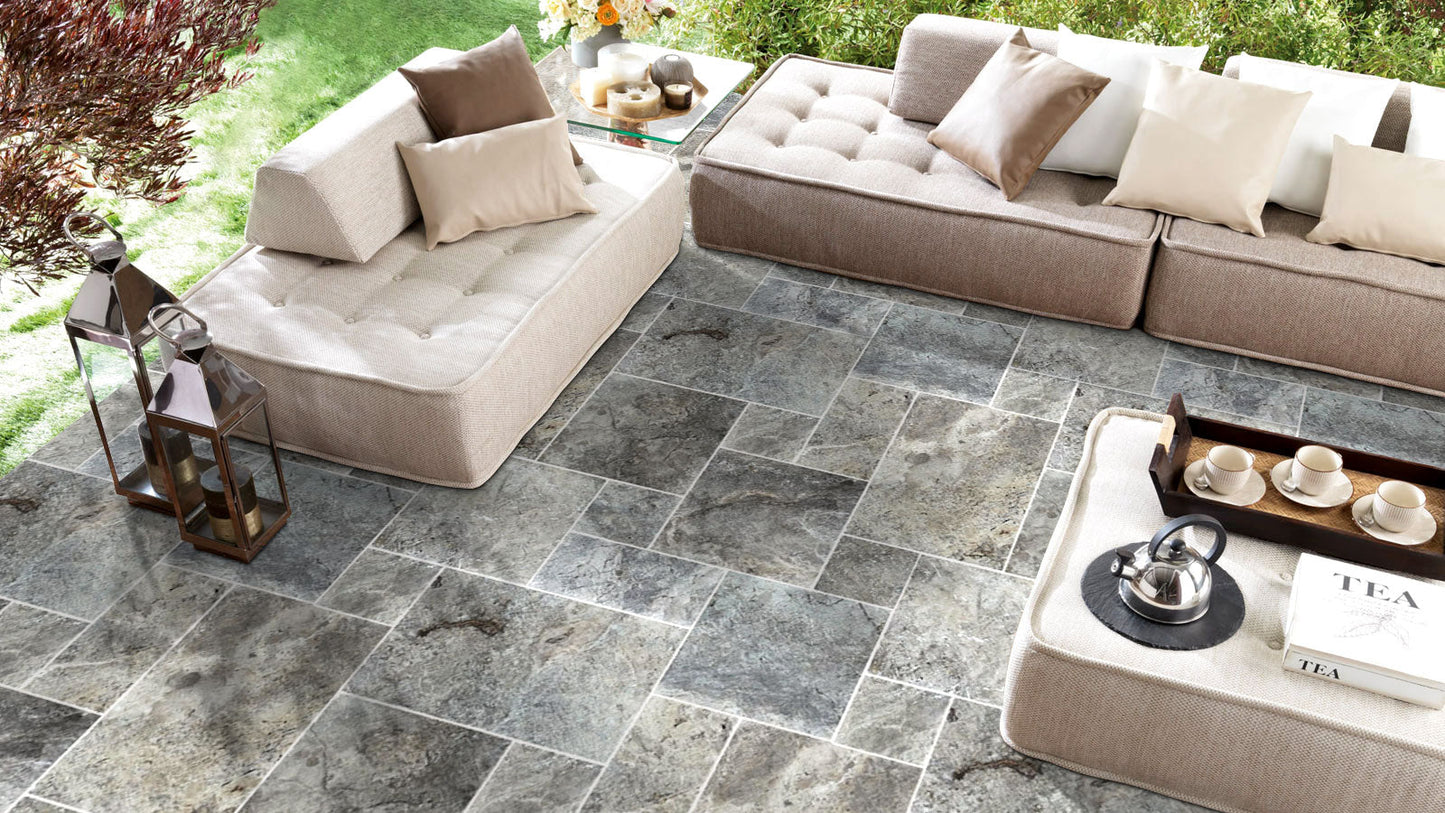 Elegant silver decor complimenting natural travertine stone for sophisticated interior design.