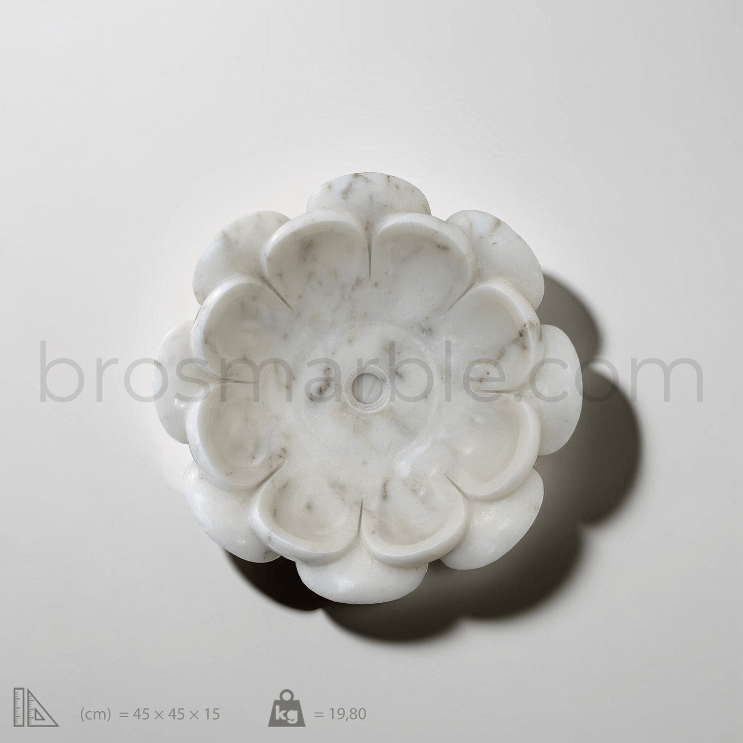 Top view of a white marble flower-shaped vessel sink with polished finish, showcasing minimalist design and craftsmanship.
