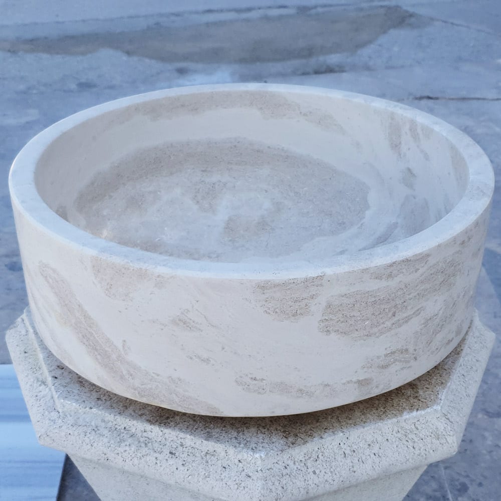Elegant limestone vessel sink showcasing natural stone texture, perfect for modern bathroom designs