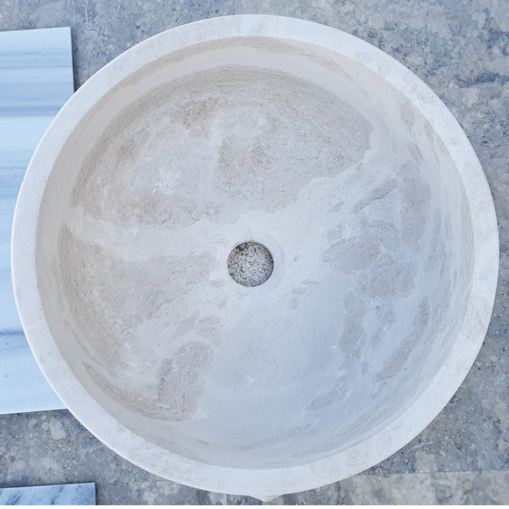 Elegant limestone vessel sink showcasing natural stone texture, perfect for modern bathroom designs