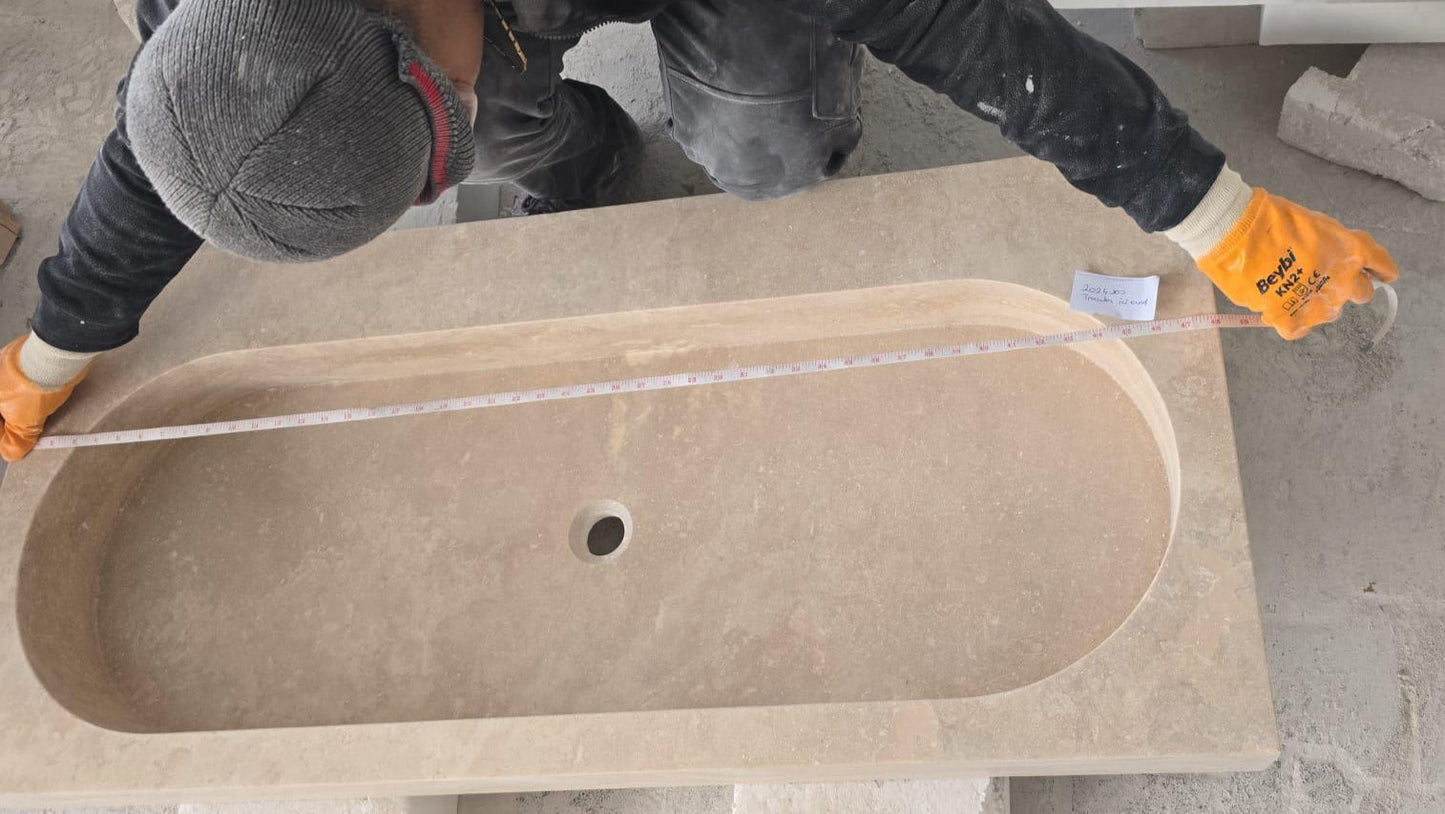 Elegant travertine bathroom sink showcasing natural stone textures for a luxurious and durable bathroom design.