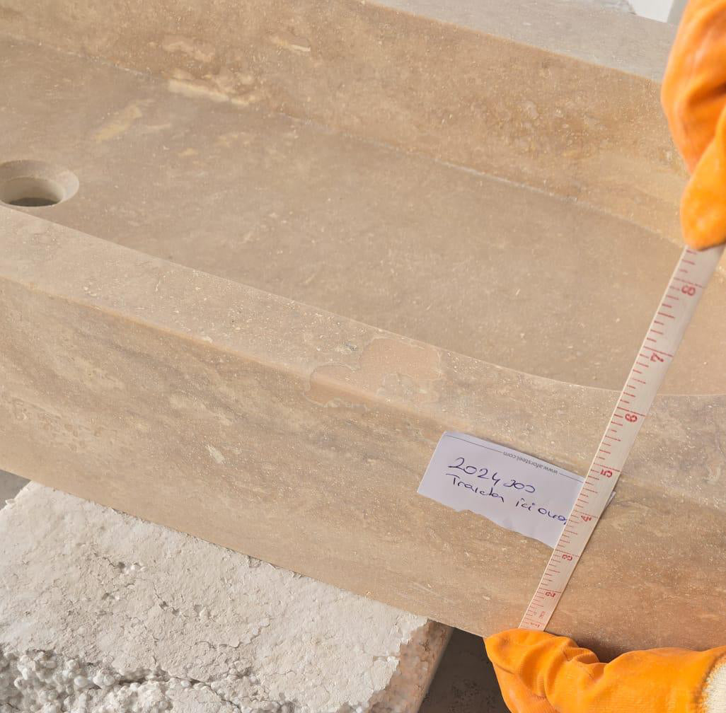 Elegant travertine bathroom sink showcasing natural stone textures for a luxurious and durable bathroom design.