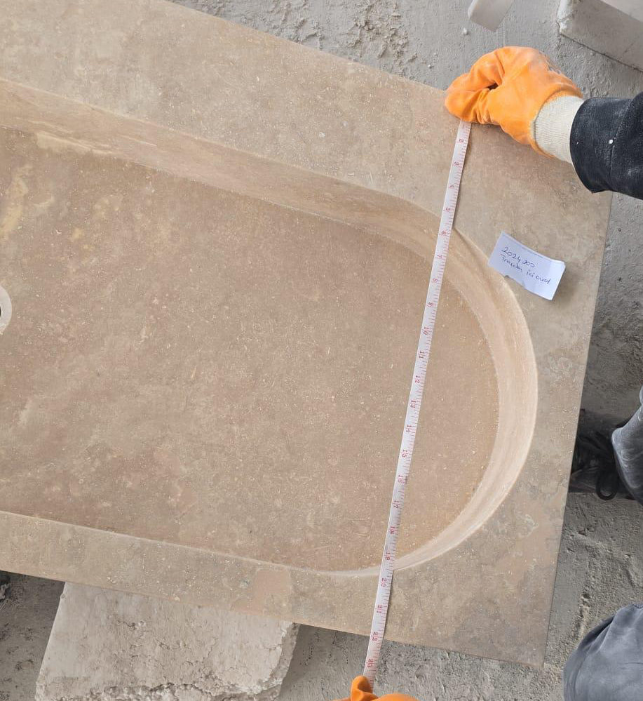 Elegant travertine bathroom sink showcasing natural stone textures for a luxurious and durable bathroom design.