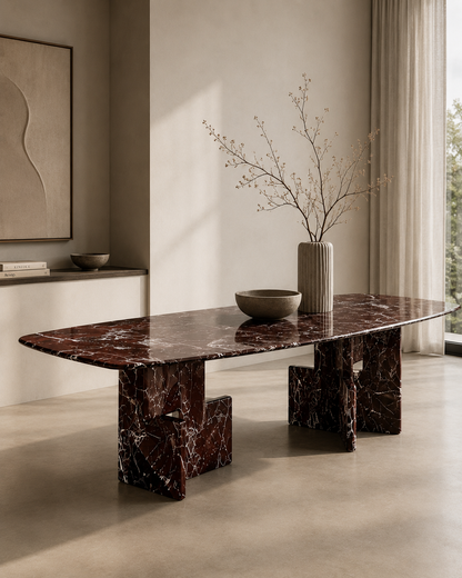 Cherry Red marble dining table seen from the side, showing the white veining across the top