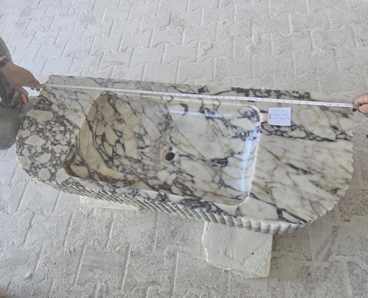 Elegant Calacatta Viola marble slab showcasing unique veining patterns and polished surface, ideal for luxurious interiors