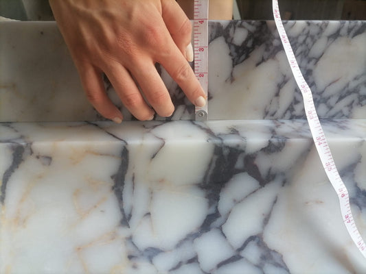 Elegant Calacatta Viola marble slab showcasing unique veining patterns and polished surface, ideal for luxurious interiors