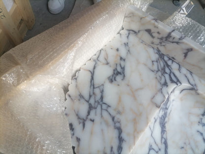 Elegant Calacatta Viola marble slab showcasing unique veining patterns and polished surface, ideal for luxurious interiors