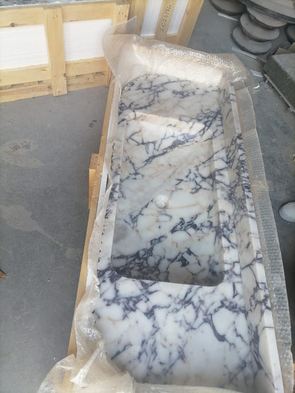 Elegant Calacatta Viola marble slab showcasing unique veining patterns and polished surface, ideal for luxurious interiors