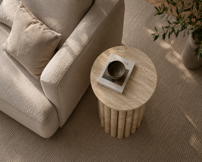 Flora Travertine Side Table top view highlighting the natural travertine texture and unique stone variations.