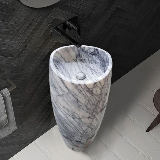 Elegant marble pedestal sink showcasing timeless design and superior craftsmanship for luxurious bathroom aesthetics