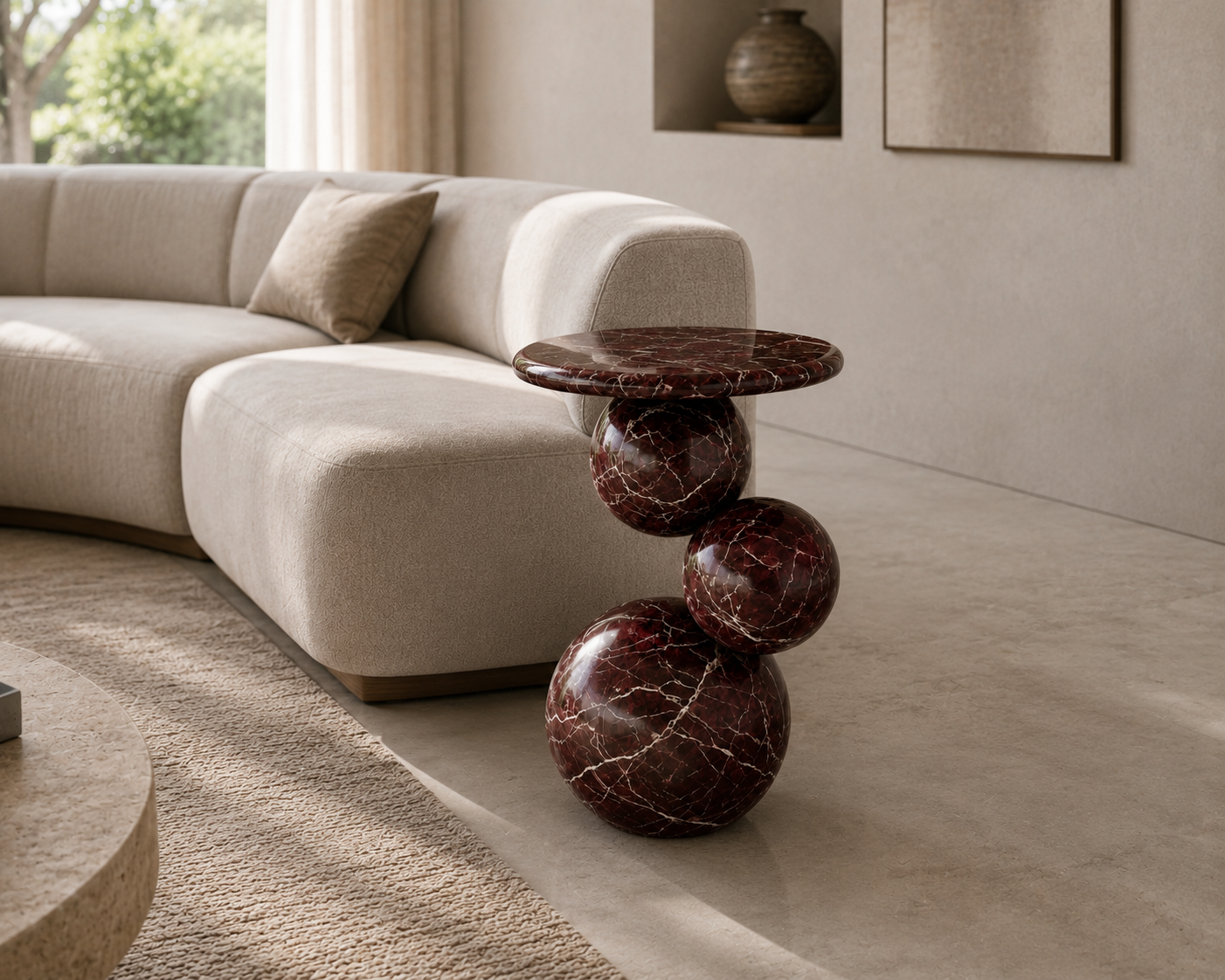 Orb Rosso Marble End Table styled beside a sofa in a luxury contemporary living room.