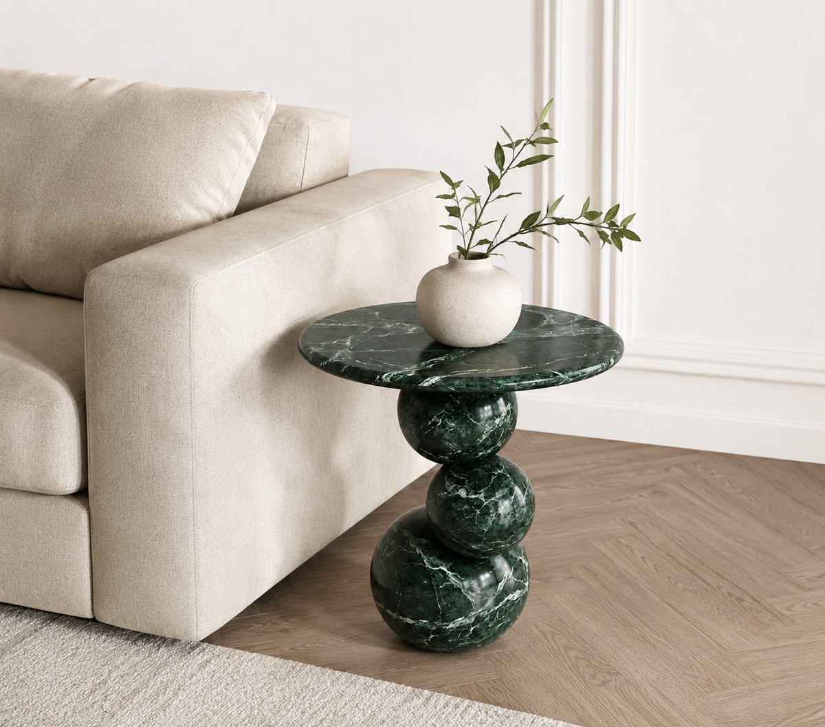 Orb Verde Marble End Table styled beside a sofa in a luxury contemporary living room.