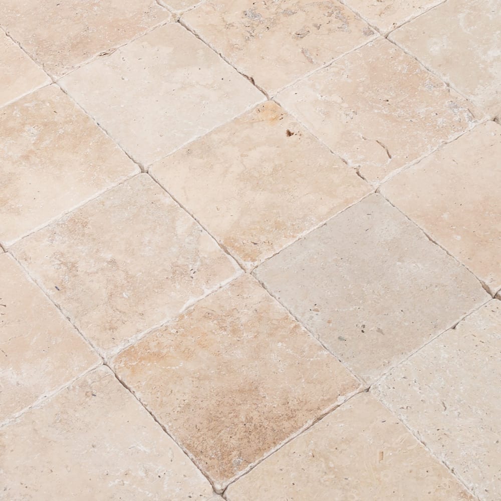 Riverbed scene showcasing smooth travertine stones along the water's edge, highlighting natural textures and serene beauty.