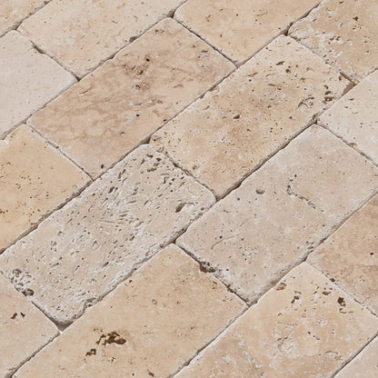 Riverbed scene showcasing smooth travertine stones along the water's edge, highlighting natural textures and serene beauty.