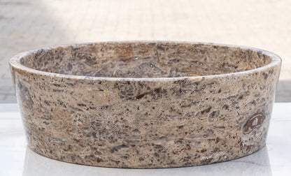 Elegant silver accents complement natural travertine textures in sophisticated interior designs.