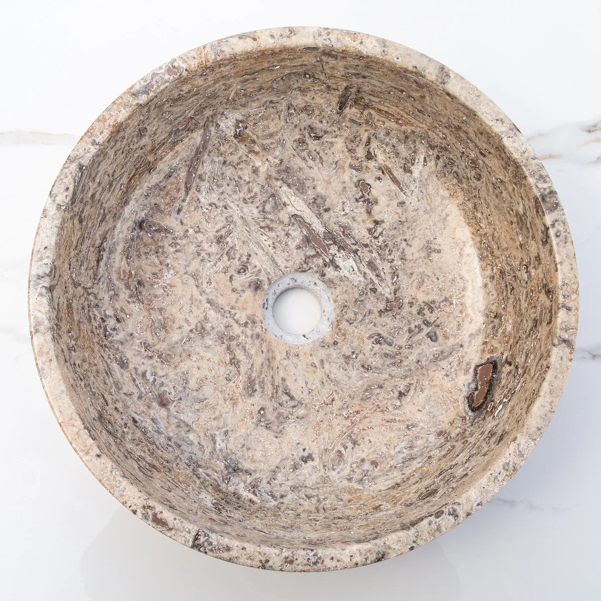 Elegant silver accents complement natural travertine textures in sophisticated interior designs.