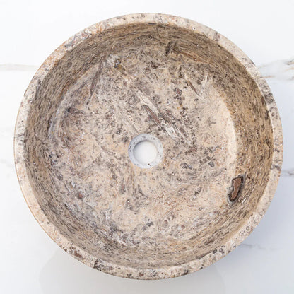 Elegant silver accents complement natural travertine textures in sophisticated interior designs.