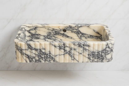 Handcrafted Calacatta Viola marble sink with bold black and white veining, perfect for luxury bathroom decor.