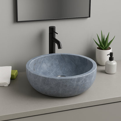 Elegant blue marble vessel sink with polished finish in a minimalist bathroom design.