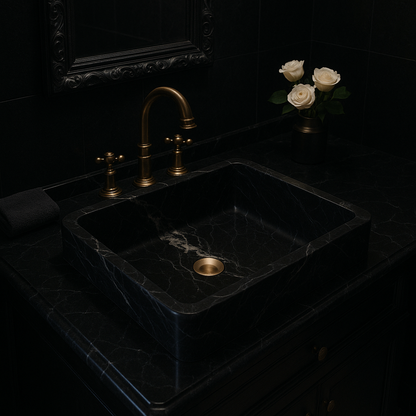 Luxury black marble vessel sink with polished finish, minimalist design, and gold faucet in an upscale bathroom.