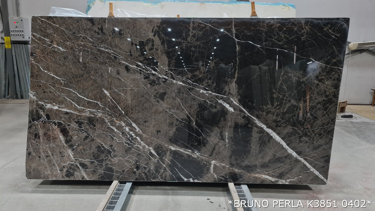 Elegant Bruno Perla design featuring luxurious brown marble surface with polished finish, perfect for upscale interiors.