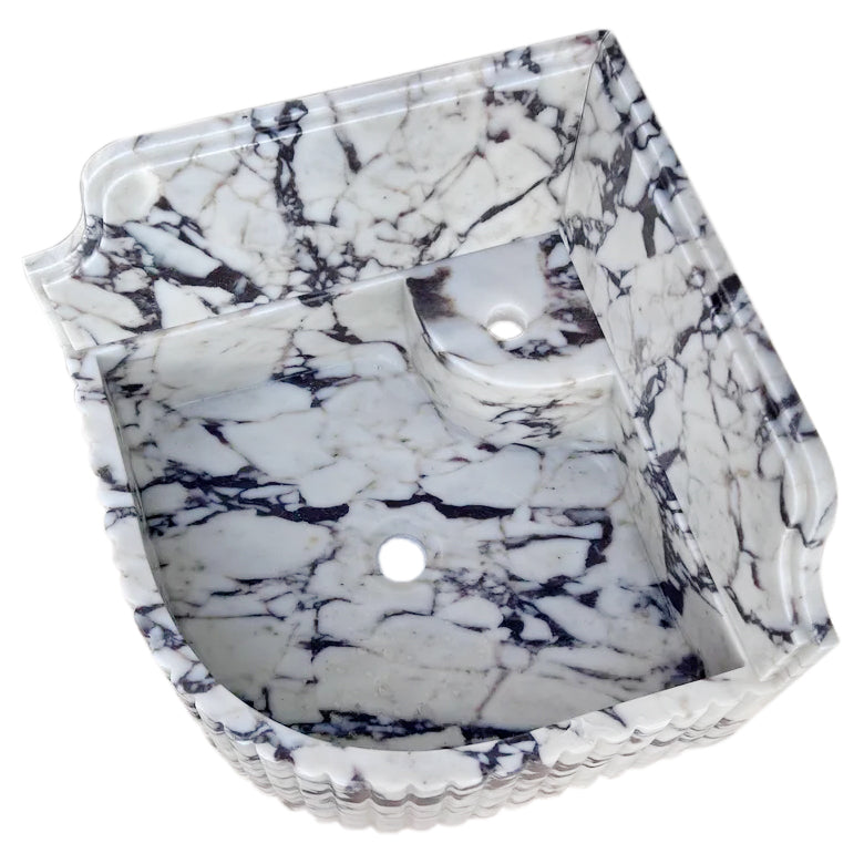 Elegant Calacatta Viola marble corner sink ideal for modern bathroom designs with luxurious stone finish.