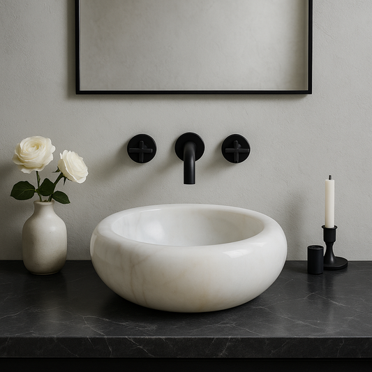 Carrara white marble sink on dark countertop with flowers and wall-mounted faucet in modern bathroom design