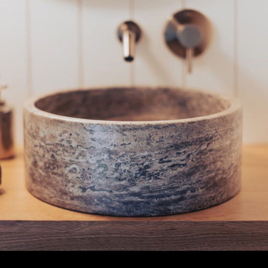 Elegant silver decor paired with natural travertine accents for a sophisticated interior design.