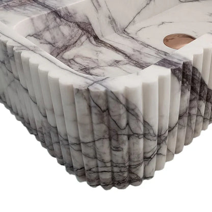 Elegant marble sink showcasing smooth texture and refined craftsmanship, perfect for modern bathroom design