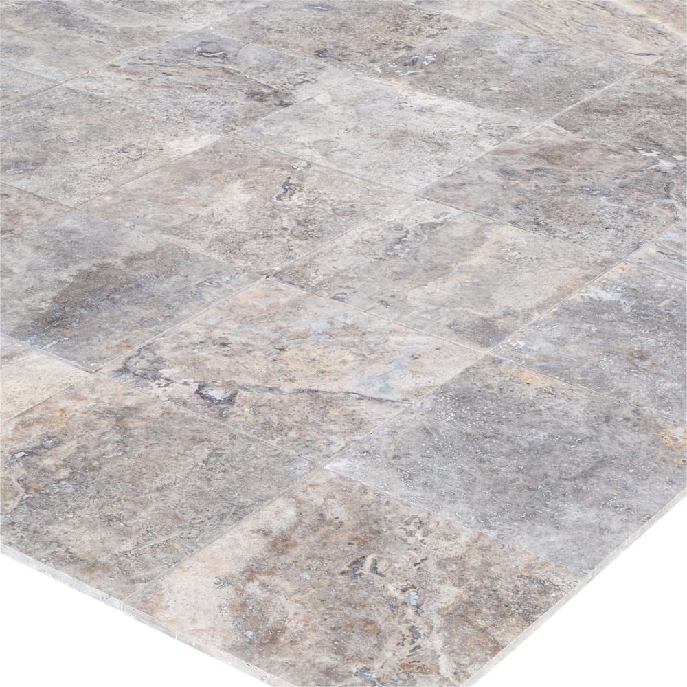 Elegant pewter vase displayed on a polished travertine surface, illustrating a blend of classic and modern decor.