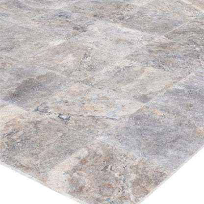 Elegant pewter vase displayed on a polished travertine surface, illustrating a blend of classic and modern decor.